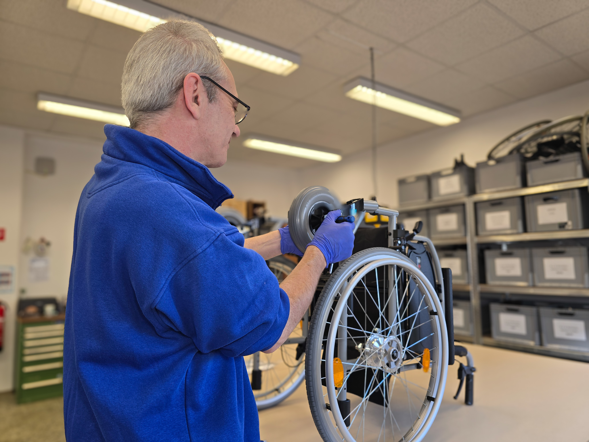 Orthopädietechniker arbeitet in der Werkstatt an einem Rollstuhl in der Rehatechnik im Wetterkreuz