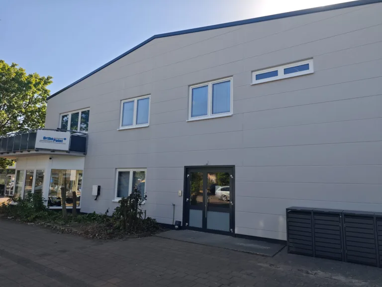 OrthoPoint Rehatechnik Filiale in Erlangen Sonnenstraße von Außen mit Mülltonnenbox und Logo